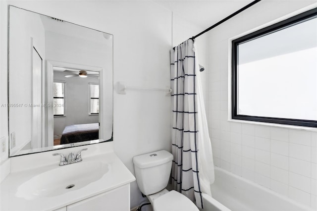 full bathroom with shower / bathtub combination with curtain, ceiling fan, vanity, and toilet