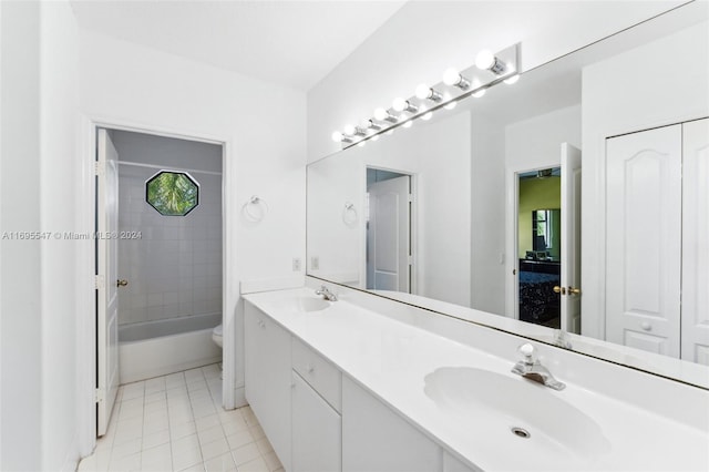 full bathroom featuring tile patterned flooring, vanity, toilet, and tiled shower / bath