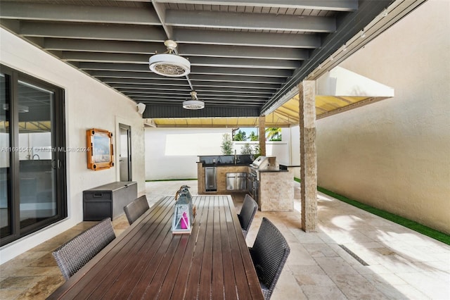 view of patio with an outdoor kitchen and area for grilling