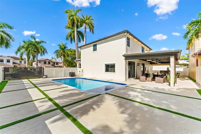 view of swimming pool with a patio area, ceiling fan, and an outdoor hangout area