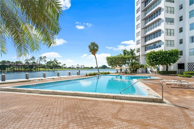 9102 W Bay Hbr Unit 4B, Bay Harbor Islands, FL 33154 - pool featuring a patio area and a water view