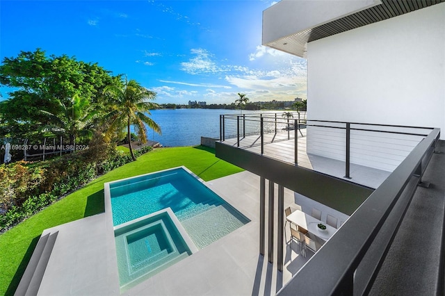 view of swimming pool featuring an in ground hot tub, a yard, and a water view