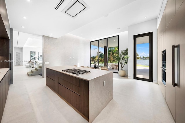 kitchen featuring a center island, dark brown cabinets, and appliances with stainless steel finishes