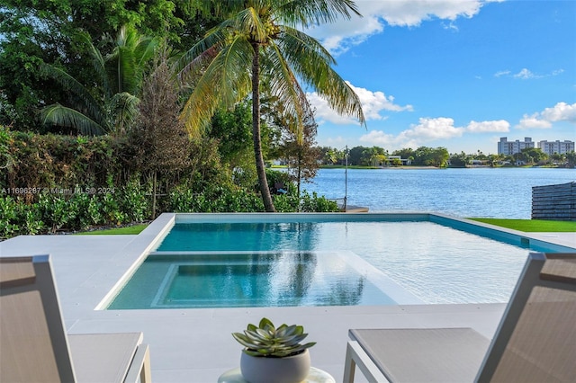 view of swimming pool featuring an in ground hot tub, a patio, and a water view