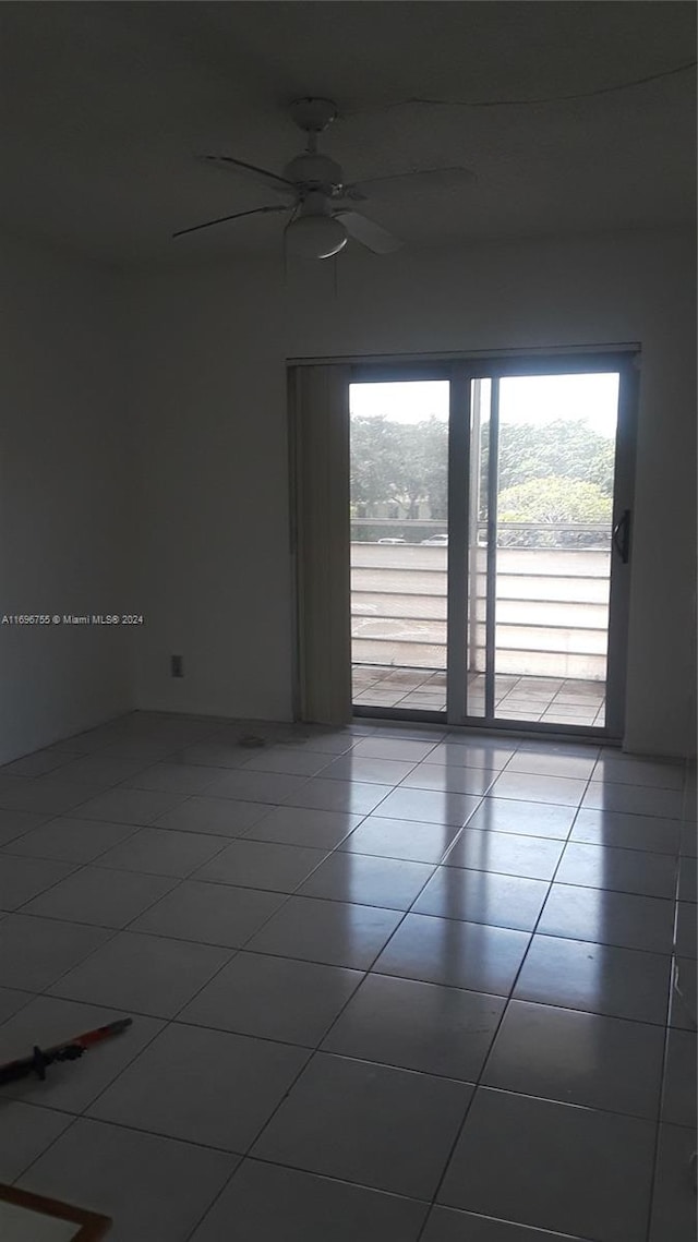 unfurnished room with tile patterned floors and ceiling fan