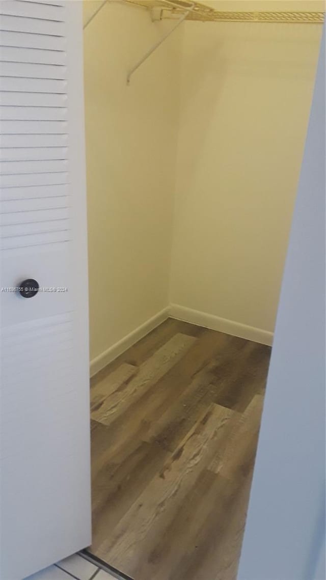 walk in closet with hardwood / wood-style floors