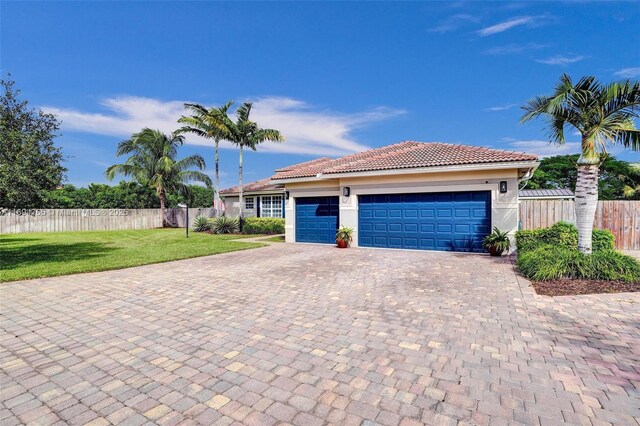 view of front facade with a garage and a front lawn