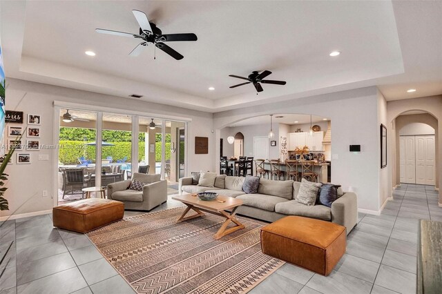 tiled living room with a tray ceiling