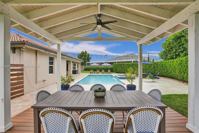 tiled dining area featuring ceiling fan and sink