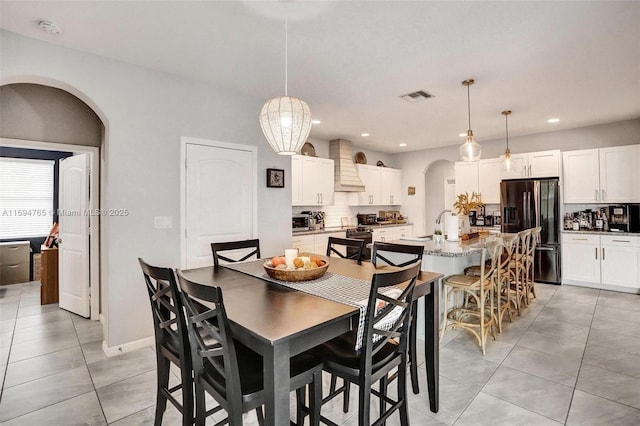 dining space featuring light tile patterned floors