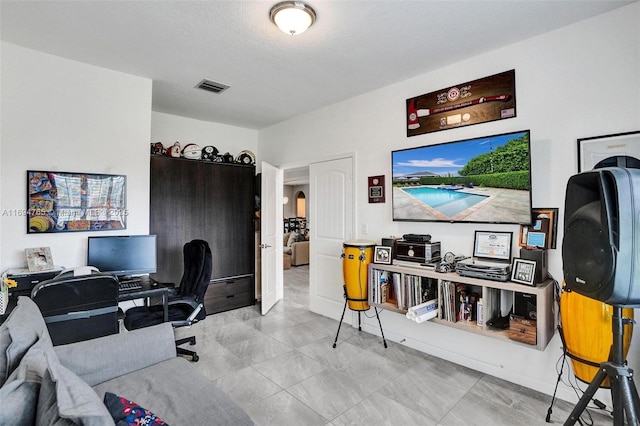 office space with a textured ceiling