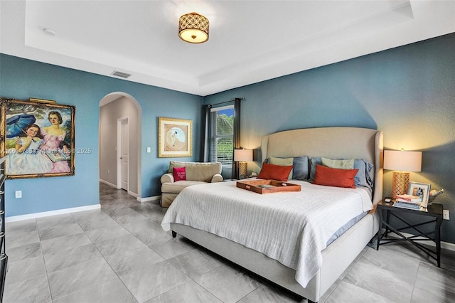 bedroom featuring a raised ceiling