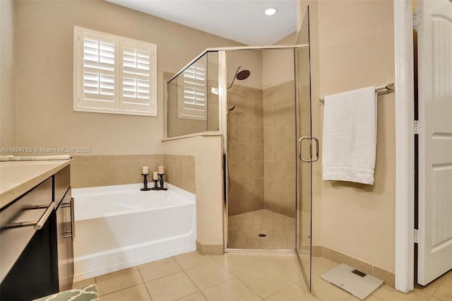 bathroom featuring tile patterned floors, vanity, and plus walk in shower