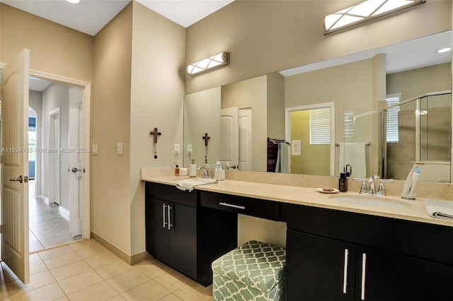 bathroom featuring tile patterned floors, vanity, and a shower with door