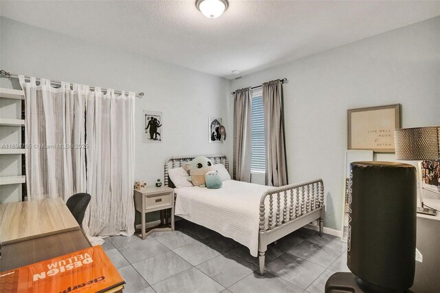 bedroom featuring light tile patterned floors