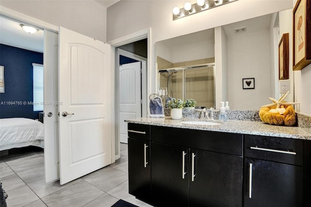 bathroom featuring vanity and an enclosed shower