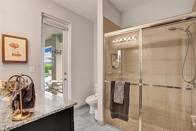 bathroom with toilet, a shower with door, tile patterned flooring, and vanity