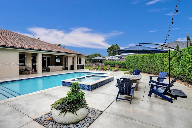 view of swimming pool with a patio area and an in ground hot tub