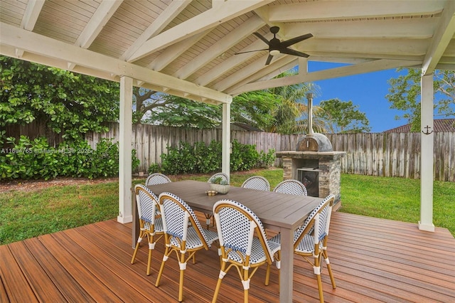 wooden terrace with a lawn and ceiling fan