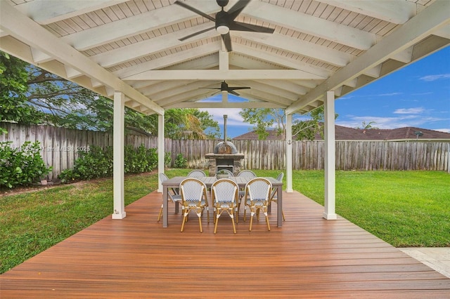 wooden terrace featuring a yard, exterior fireplace, and ceiling fan