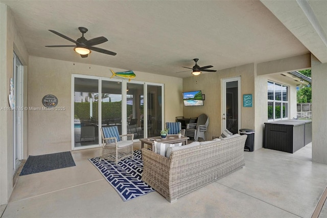 view of patio with outdoor lounge area and ceiling fan