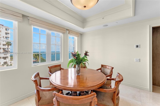 tiled dining room with a water view