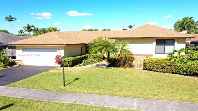 single story home with a garage and a front yard