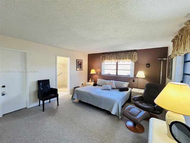 carpeted bedroom featuring connected bathroom and a textured ceiling