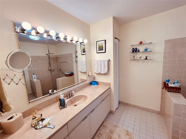 bathroom featuring tile patterned floors, vanity, and tiled shower