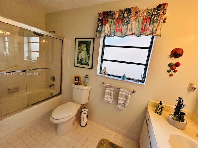 full bathroom with shower / bath combination with glass door, tile patterned floors, vanity, and toilet