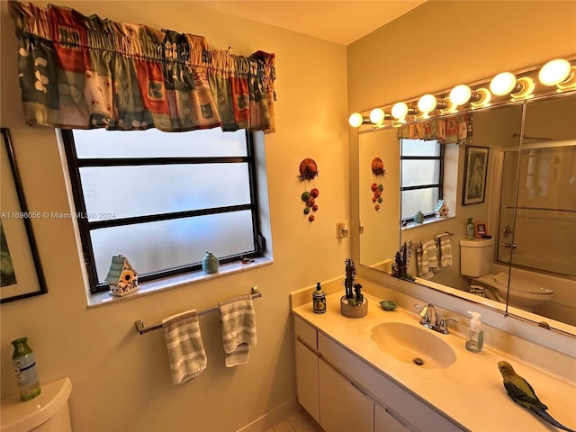 full bathroom with tile patterned floors, toilet, vanity, and combined bath / shower with glass door