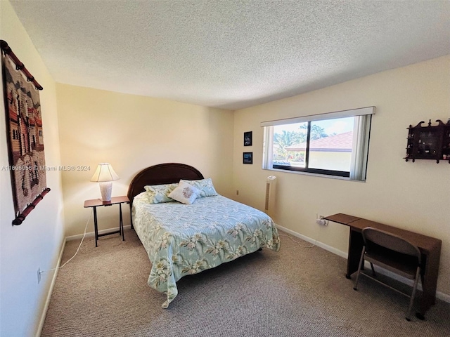 bedroom with carpet and a textured ceiling