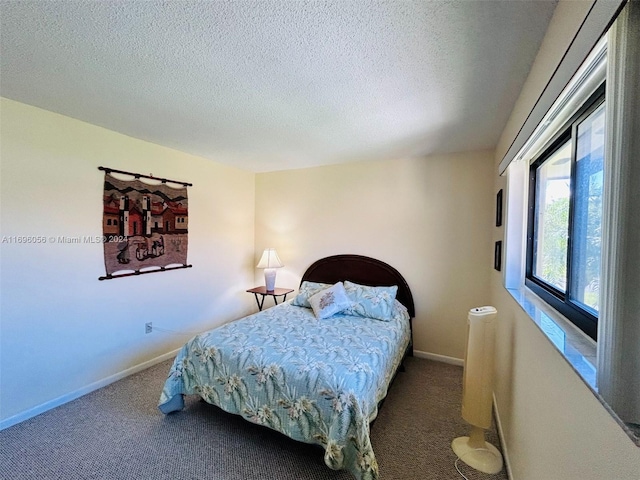 bedroom featuring carpet floors and a textured ceiling