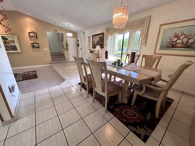 tiled dining room featuring lofted ceiling, a textured ceiling, and an inviting chandelier