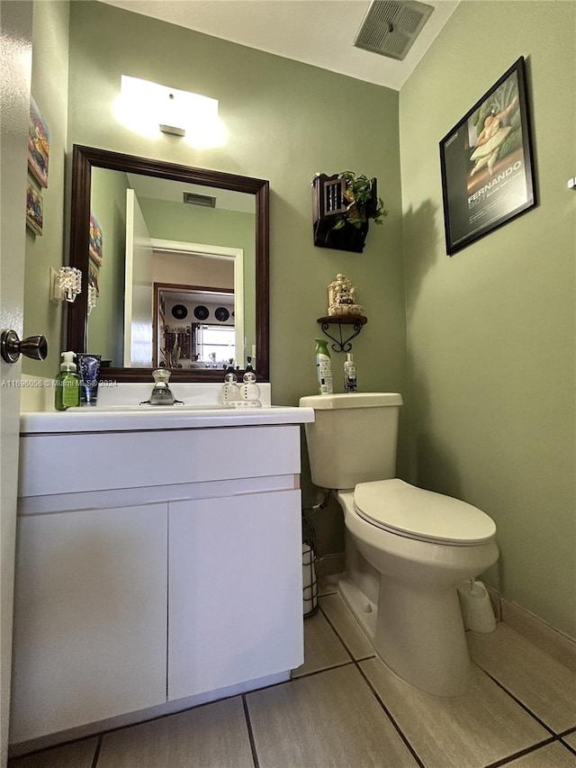 bathroom with tile patterned floors, vanity, and toilet