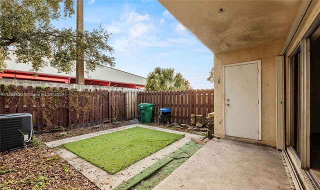 view of yard featuring a patio area and central AC