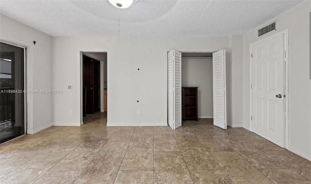 unfurnished bedroom featuring a textured ceiling