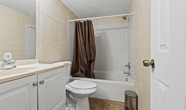 full bathroom with vanity, toilet, tile walls, and shower / tub combo