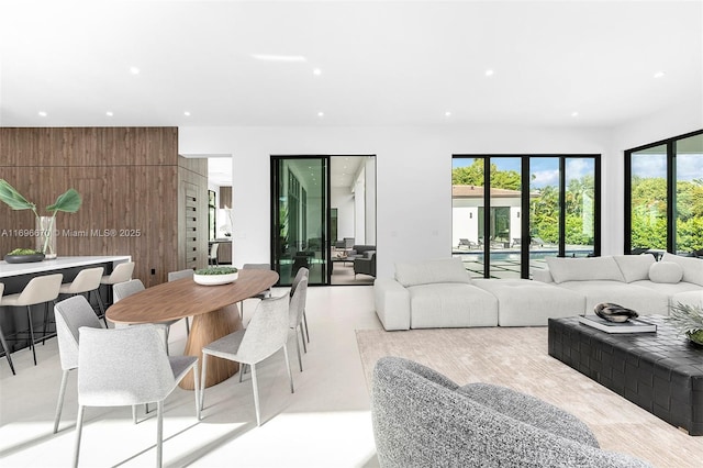 living room with wood walls and a wealth of natural light