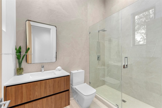 bathroom featuring vanity, toilet, tile walls, and a shower with shower door