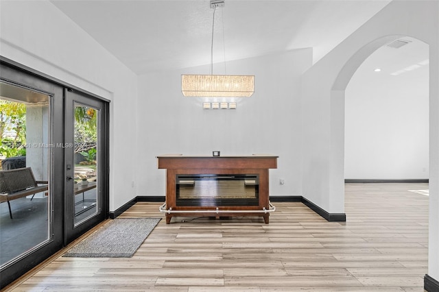 dining area featuring light hardwood / wood-style flooring and vaulted ceiling