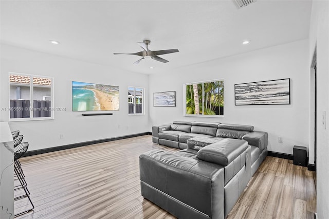 living room featuring ceiling fan and light wood-type flooring