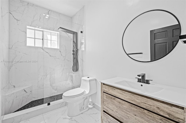 bathroom with a tile shower, vanity, and toilet