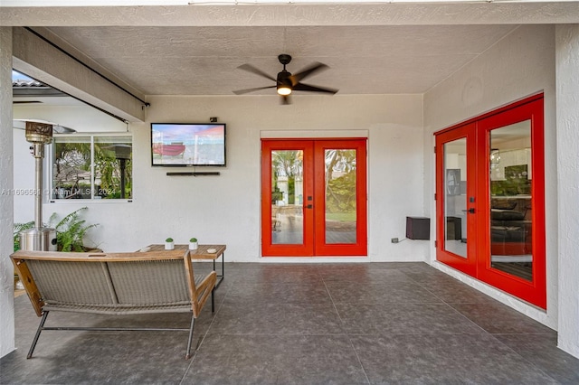 interior space with ceiling fan, french doors, and a patio