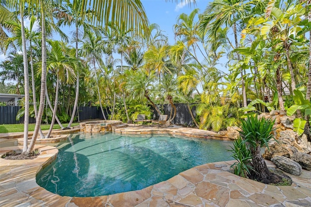 view of swimming pool with an in ground hot tub