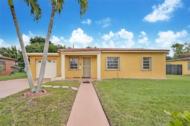 view of front of home with a front yard and a garage