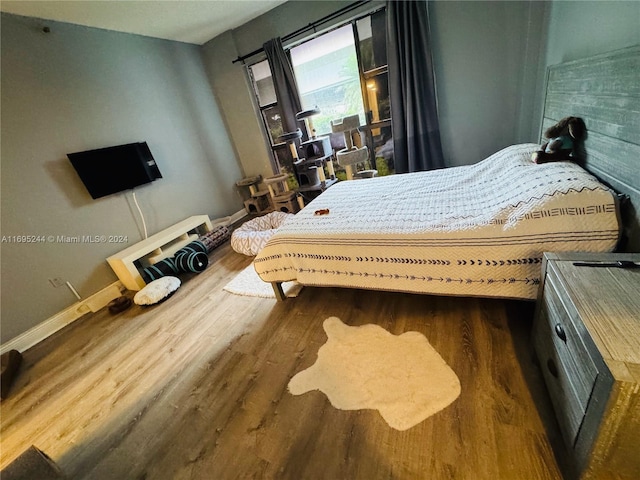 bedroom featuring dark hardwood / wood-style flooring