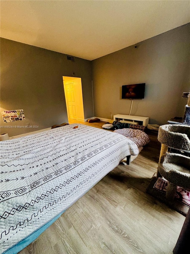 bedroom with wood-type flooring