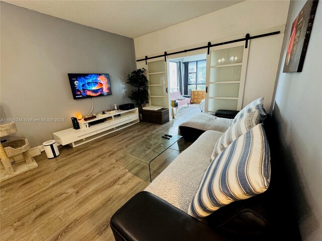 living room featuring hardwood / wood-style floors and a barn door