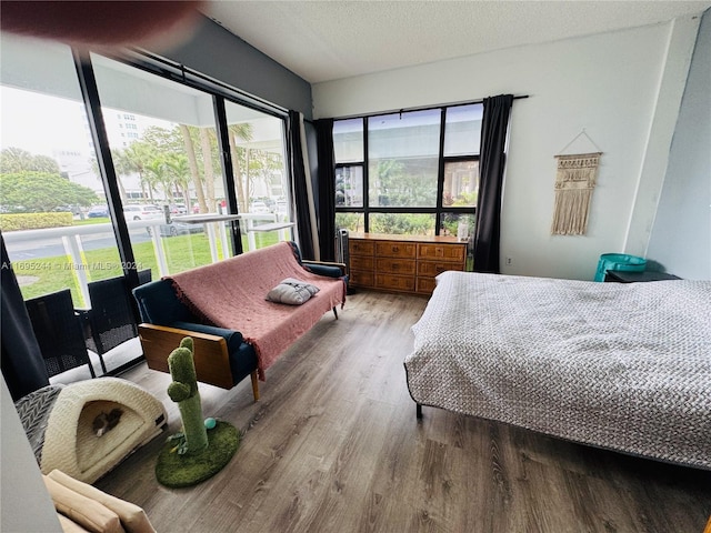 bedroom featuring light wood-type flooring and a textured ceiling